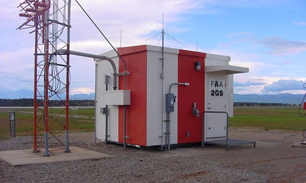 JQMC FAA glide slope shelter with red-and-white checkerboard markings on airfield